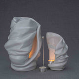 Light Cremation Urn and Ashes Keepsake Urn in White Turned Right with Candle Holder Dark Background