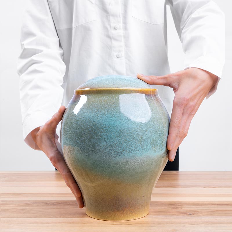 Ocean Blue Classic Cremation Urn for Ashes Being Held