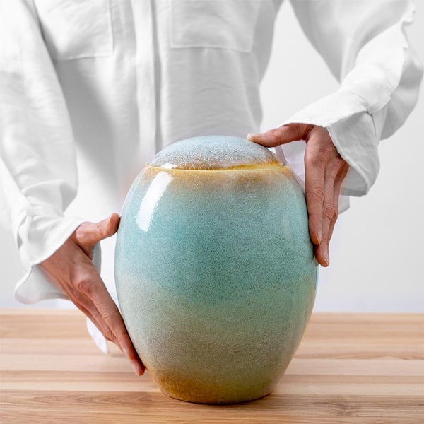 Ocean Blue Modern Creation Urn for Ashes Being Held