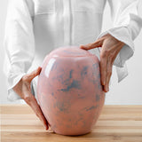 Pink Sky Modern Cremation Urn for Ashes Being Held