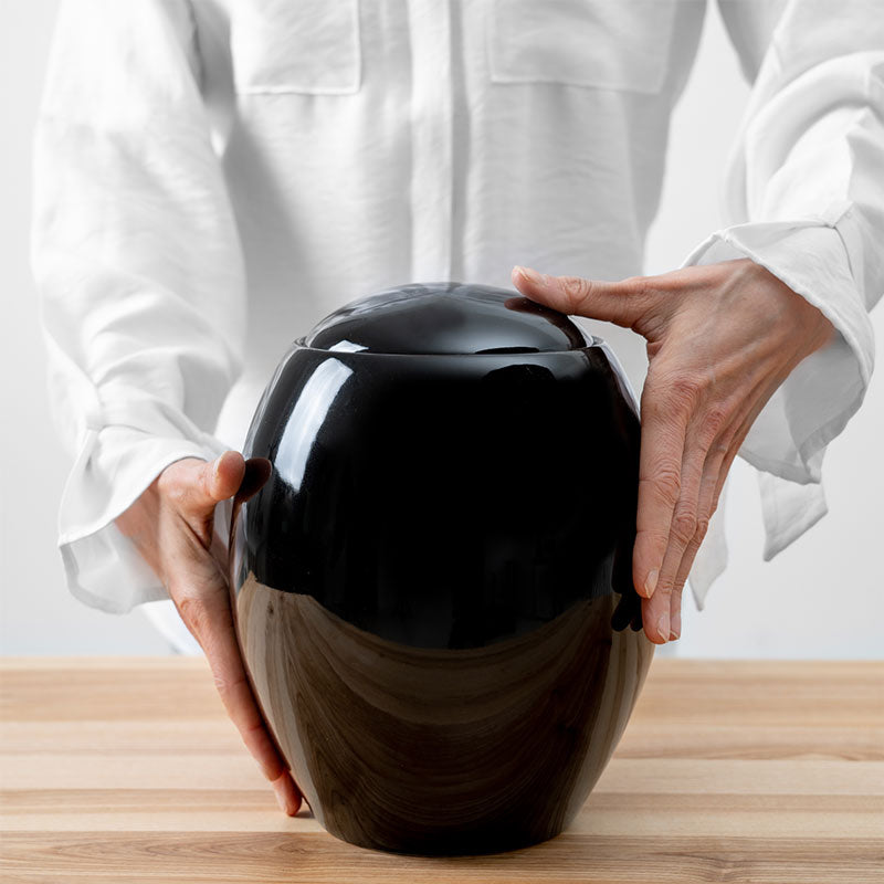 Pure Black Modern Cremation Urn for Ashes Being Held