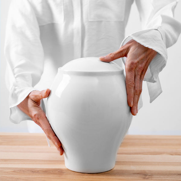 Pure White Classic Cremation Urn for Ashes Being Held