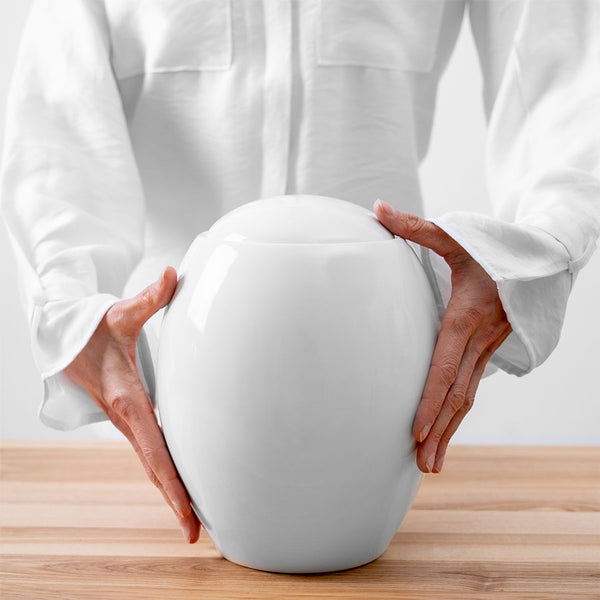 Pure White Modern Cremation Urn for Ashes Being Held