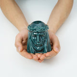 The Christ Ashes Keepsake Urn Green in Hands