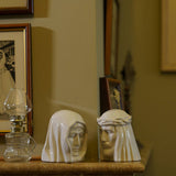 The Christ Ashes Keepsake Urn with The Holy Mother Ashes Keepsake Cream on Fireplace Facing Each Other