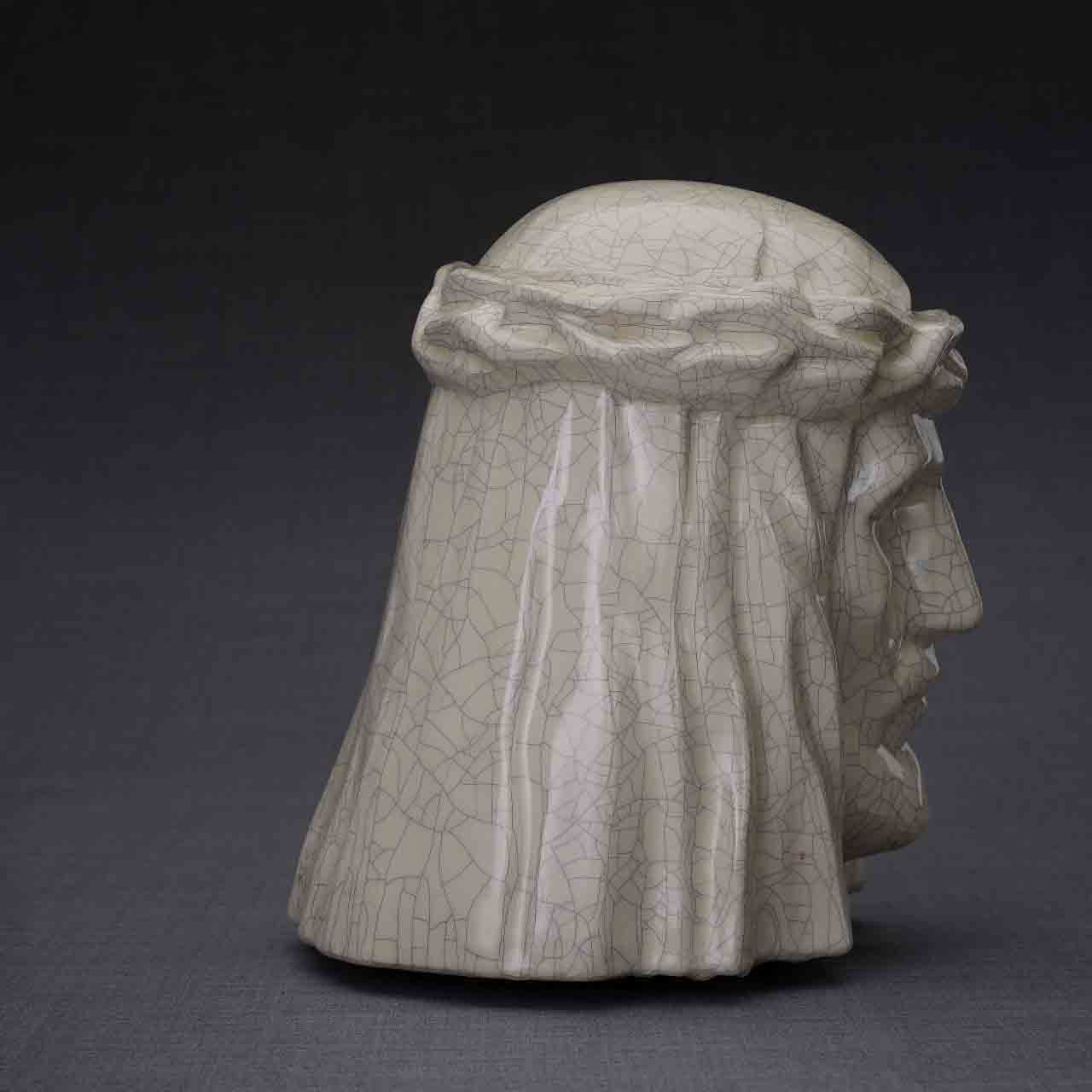 The Christ Cremation Urn for Ashes in Crackle Glaze Facing Right Dark Background