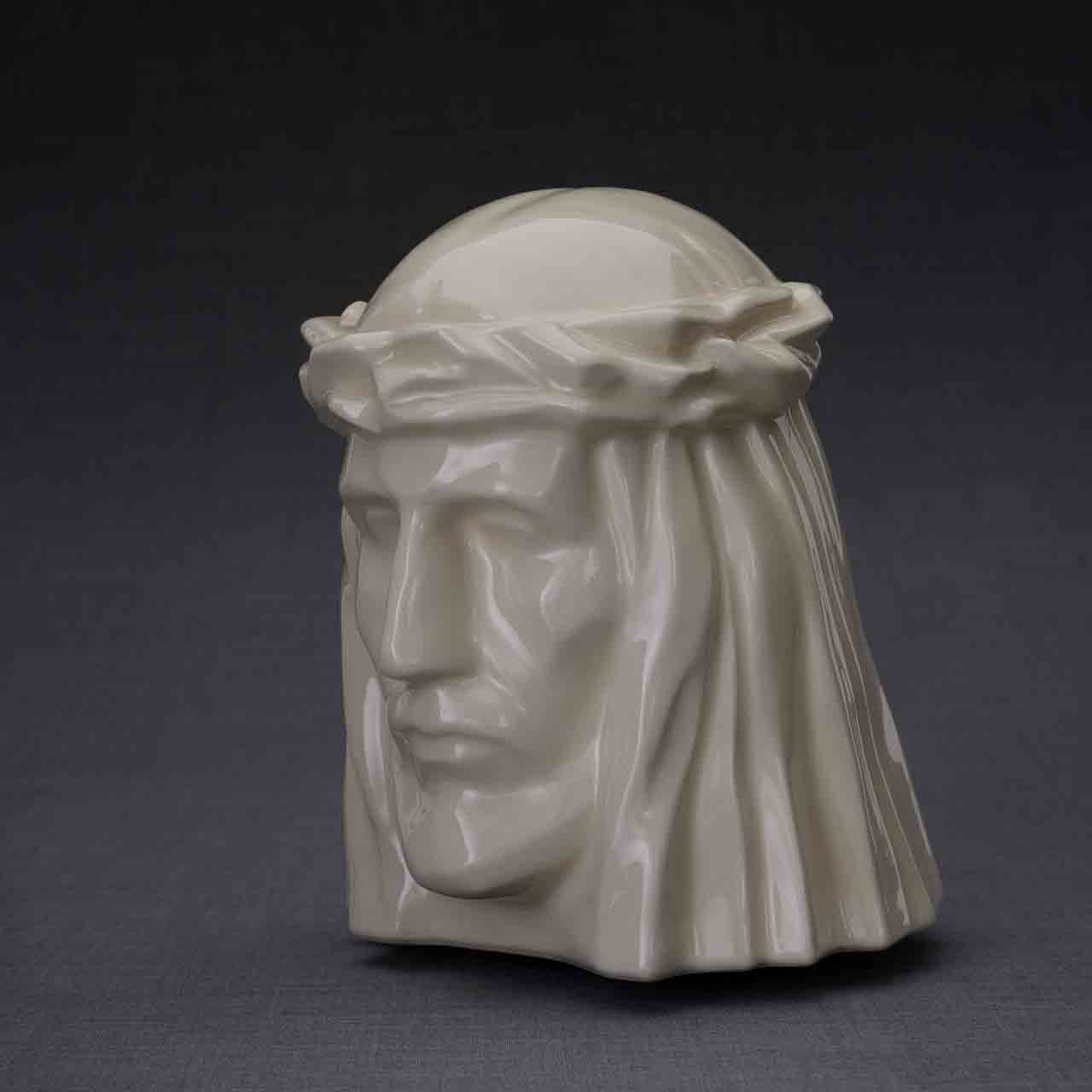 The Christ Cremation Urn for Ashes in Cream Turned Left Dark Background