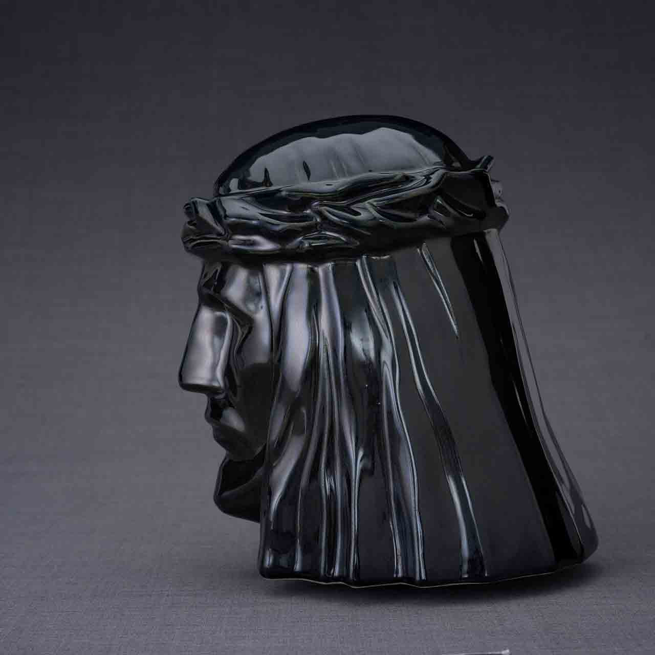 The Christ Cremation Urn for Ashes in Glossy Black Facing Left Dark Background