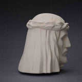 The Christ Cremation Urn for Ashes in Matte White Facing Right Dark Background