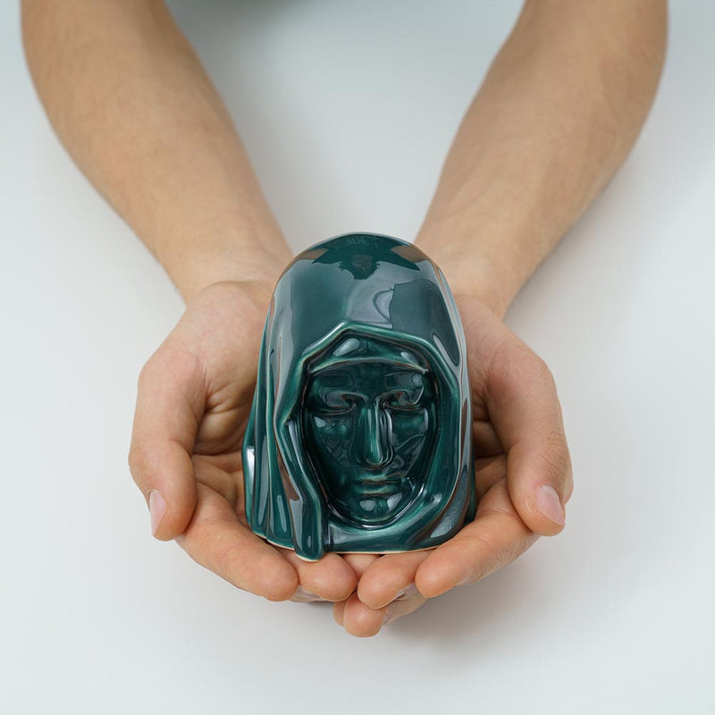 The Holy Mother Ashes Keepsake Urn Green in Hands
