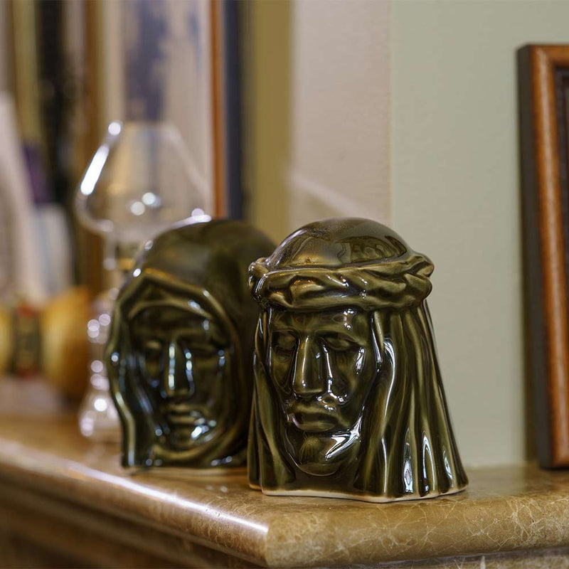 The Holy Mother Ashes Keepsake Urn with The Christ Ashes Keepsake Brown on Fireplace