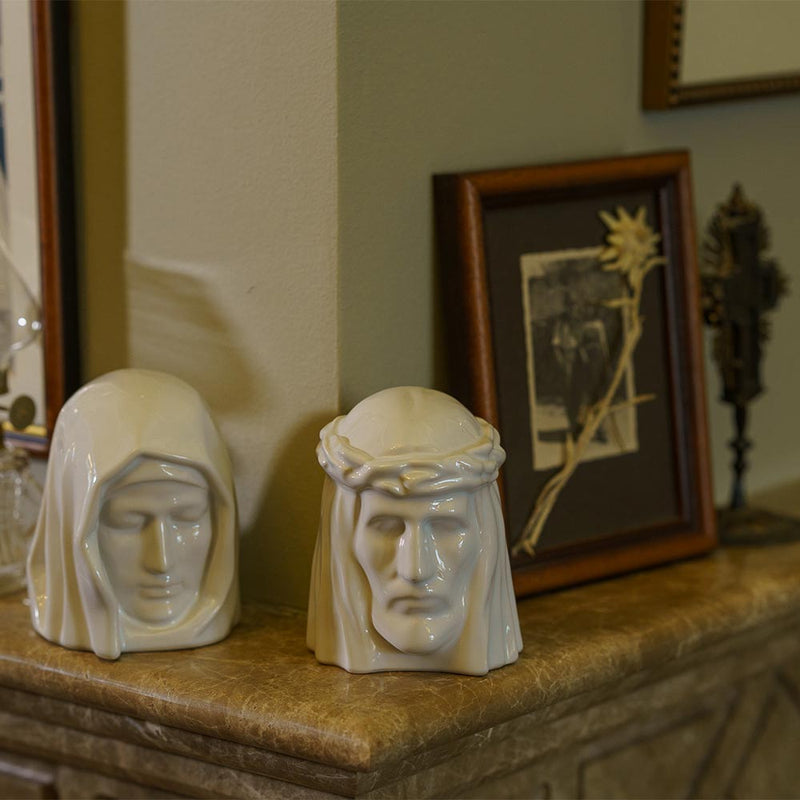 The Holy Mother Ashes Keepsake Urn with The Christ Ashes Keepsake Cram on Fireplace