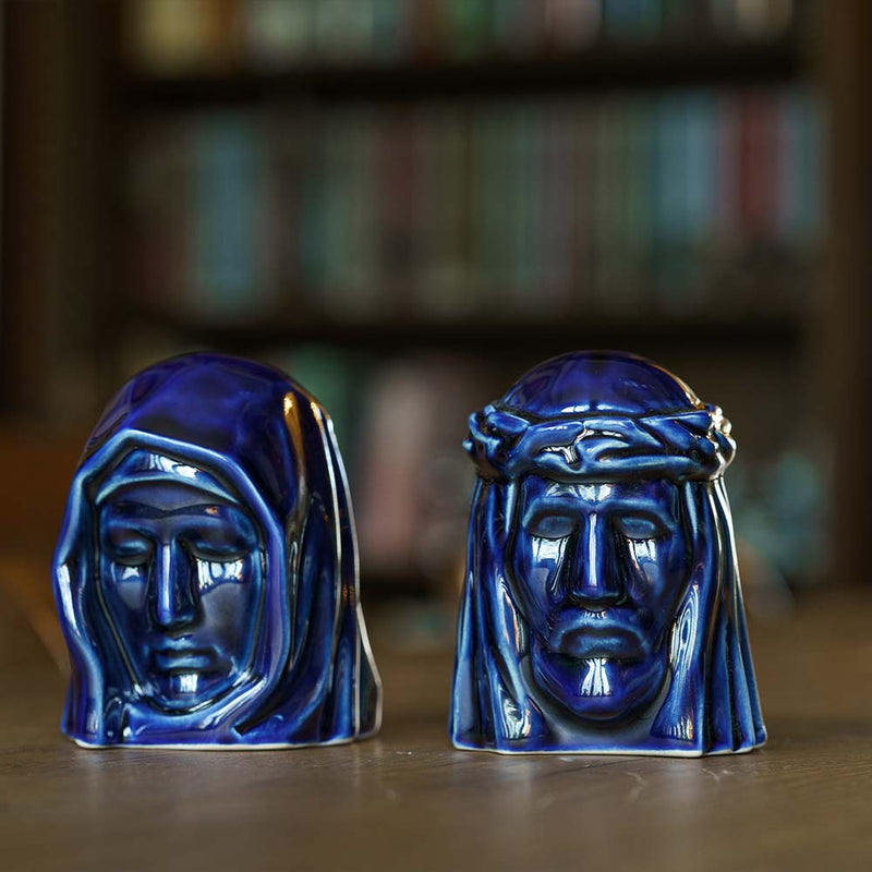 The Holy Mother Ashes Keepsake Urn with The Christ Ashes Keepsake Metallic Blue on Table