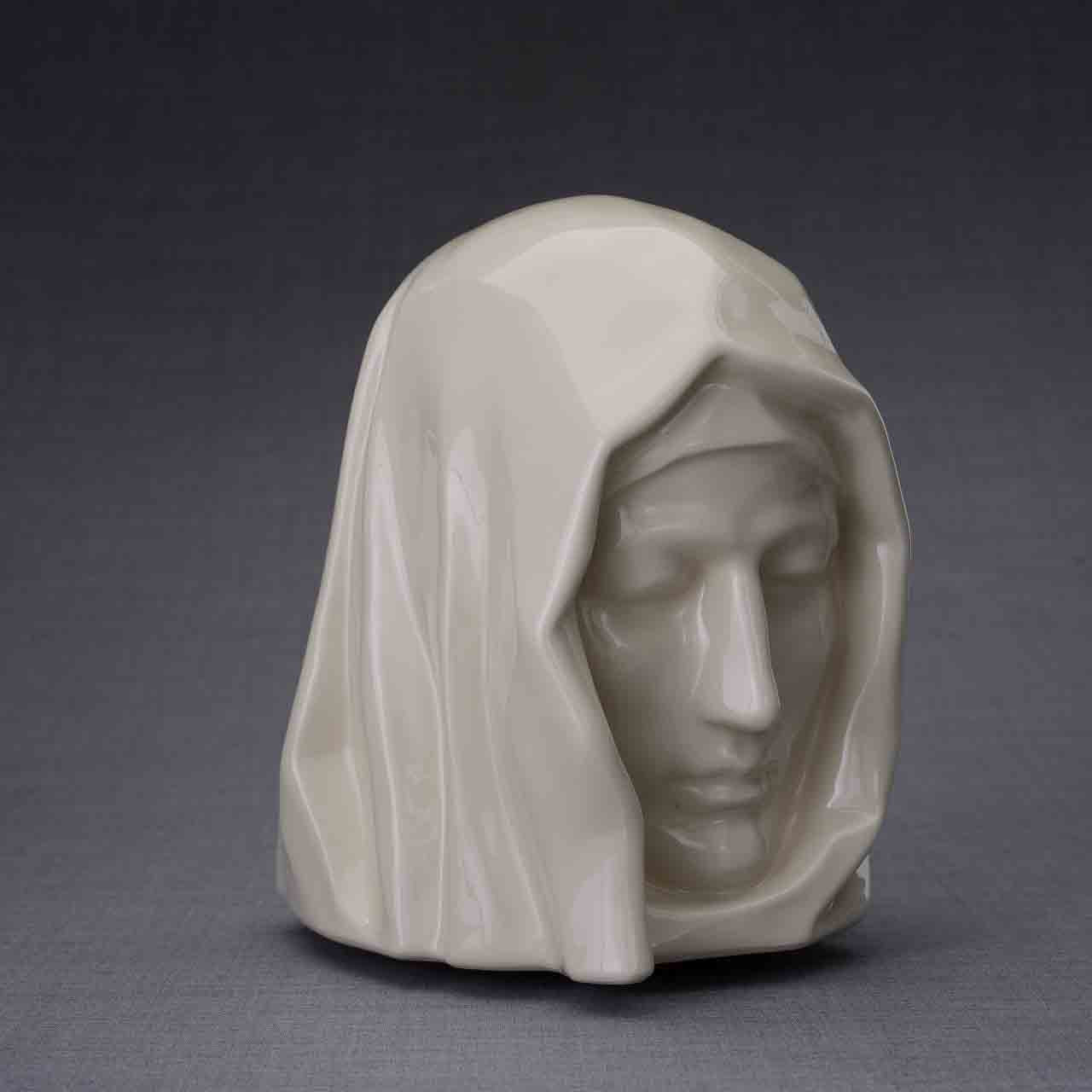 The Holy Mother Cremation Urn for Ashes in Cream Turned Right Dark Background