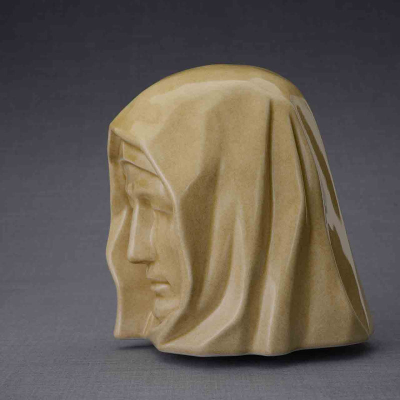 The Holy Mother Cremation Urn for Ashes in Light Sand Facing Left Dark Background
