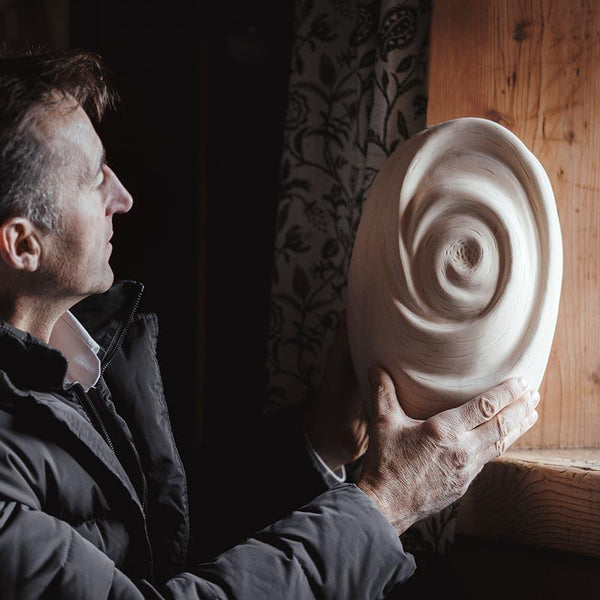 The Tranquility Cremation Urn for Ashes being held