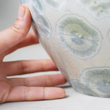 White Calcite Cremation Urn for Ashes - Adult Close up with Hand